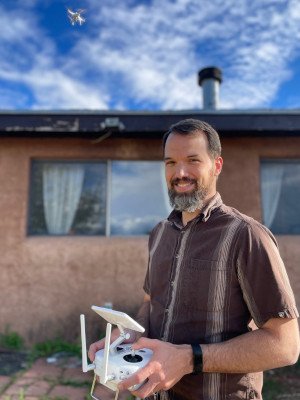 Portrait of Jeffrey Roth, founder of Aerial inSight, flying a drone